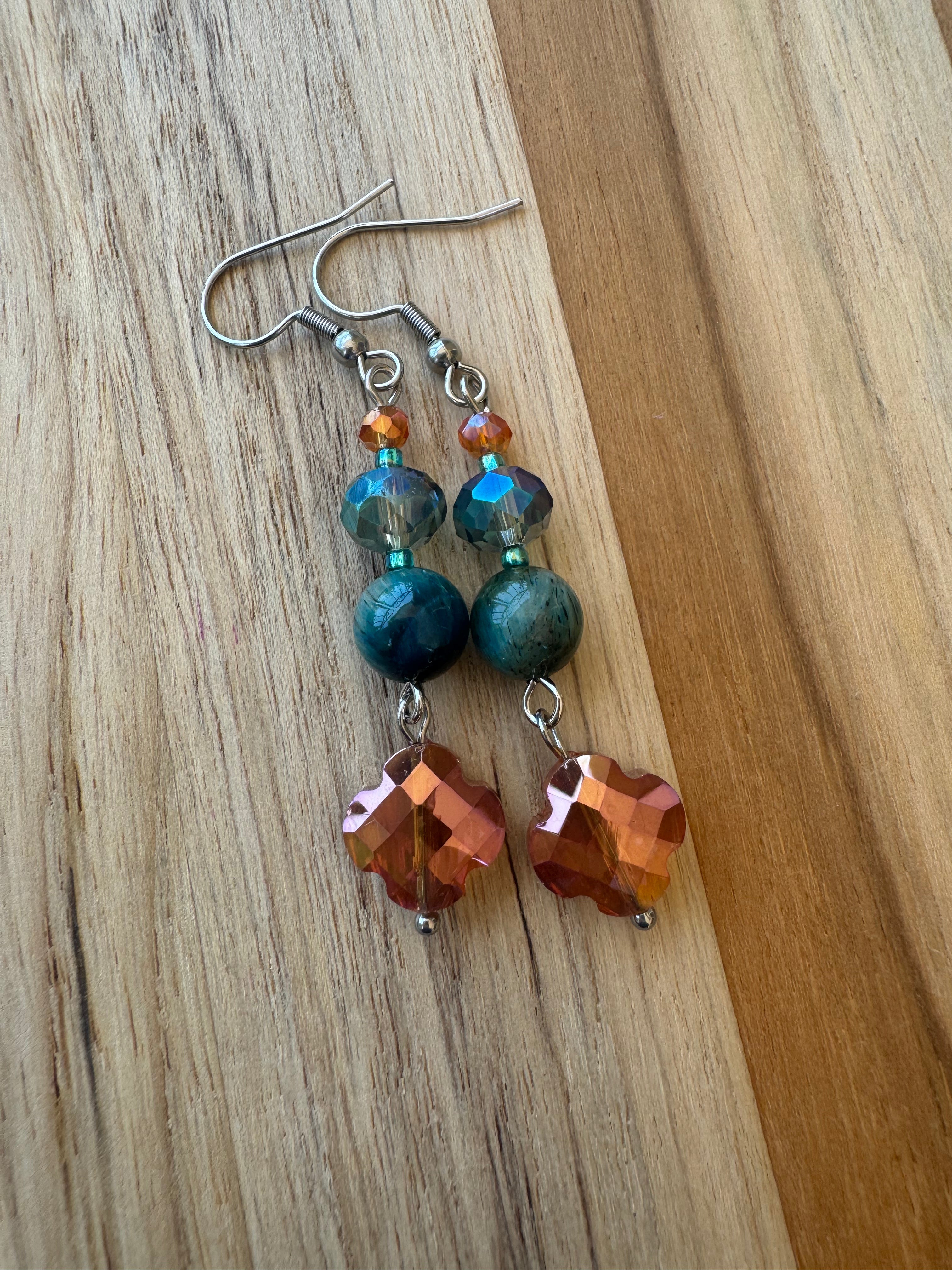 Beautiful orange colored Czech glass flower earrings with pale green jade and crystals. stainless steel lever back.