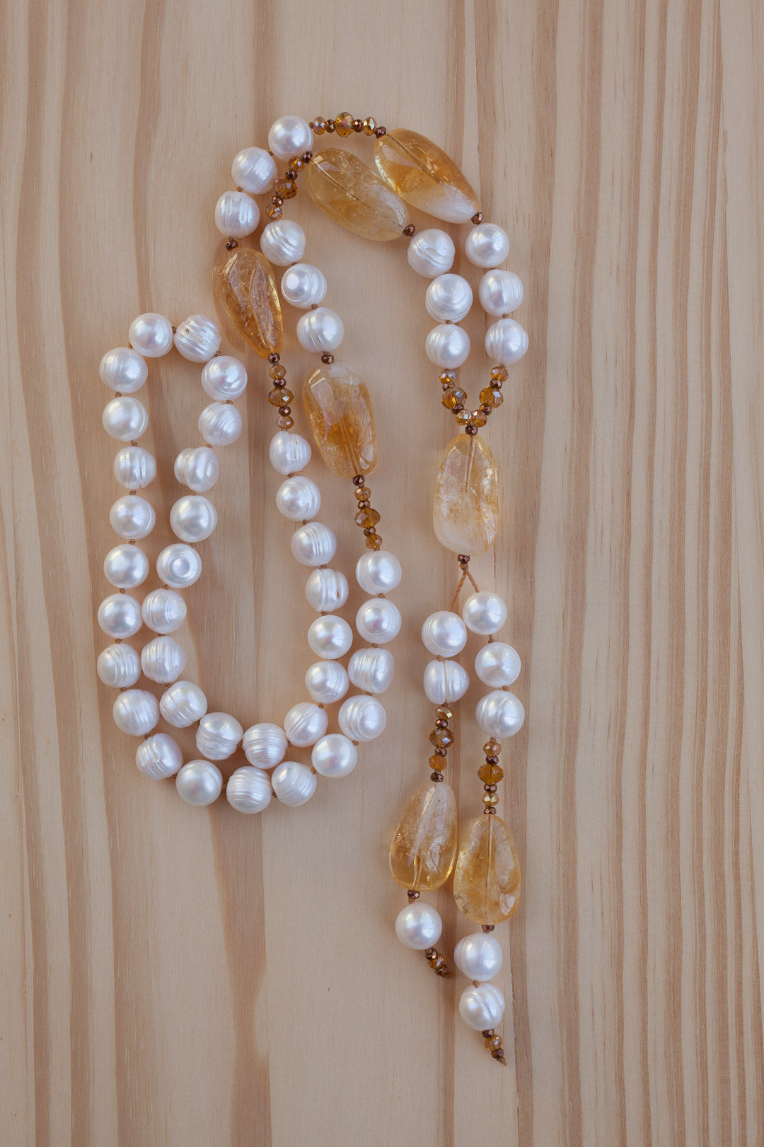 Long hand knotted white freshwater pearl necklace with citrine nuggets and crystal beads